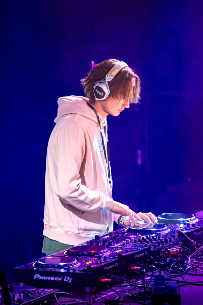 DJ aux platines dans la lumière bleue et violette du club